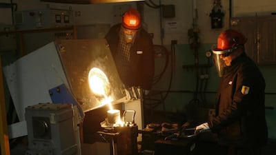 Workers cast an ingot of 99.98 per cent pure platinum at the Krastsvetmet non-ferrous metals plant in Siberia. Ilya Naymushin / Reuters