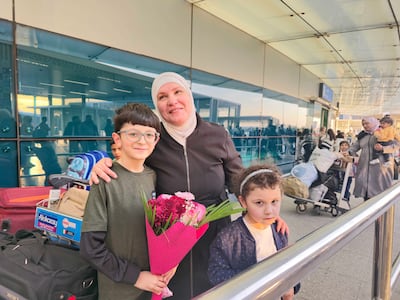 Feryal Tartoussi was greeted by her grandchildren after arriving at Sharjah International Airport from Damascus. Salam Al Amir / The National