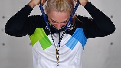 Gold medallist Slovenia's Janja Garnbret celebrates on the podium of the women's sport climbing medal ceremony.