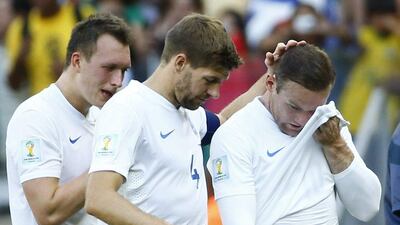Phil Jones, Steven Gerrard and Wayne Rooney react after their draw against Costa Rica on Tuesday at the 2014 World Cup. The match was their last at Brazil 2014. Murad Sezer / Reuters / June 24, 2014