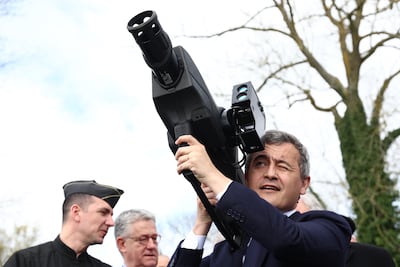 France's Interior Minister Gerald Darmanin holds a SkyWall Patrol anti-drone device. Photo: AFP