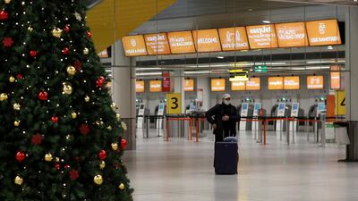 FILE PHOTO: A passenger stands in an almost empty check-in area at Gatwick Airport, amid the coronavirus disease (COVID-19) outbreak, in Crawley, Britain, November 27, 2020. REUTERS/Peter Nicholls/File Photo