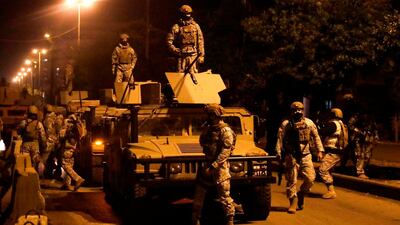 Lebanese security forces stand guard during clashes with anti-government protesters in the northern city of Tripoli, on January 29, 2021. AFP