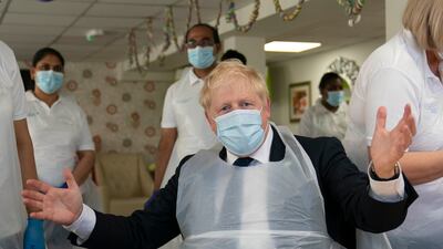 Boris Johnson during a visit to Westport Care Home in Stepney Green, ahead of unveiling his long-awaited plan to fix the social care system, in September 2021. Getty Images