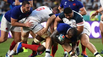 TOPSHOT - France's flanker Yacouba Camara (2R) is tackled by US prop Titi Lamositele (R) during the Japan 2019 Rugby World Cup Pool C match between France and the United States at the Fukuoka Hakatanomori Stadium in Fukuoka. AFP