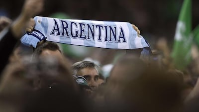 An Argentina supporter holds a scarf before the quarter final match. Franck Fife / AFP