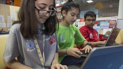 From left, Dana Ahmed, Reem Al Amiri and Khalil Kashwani – all Grade 4 pupils at the Australian International School in Sharjah – practise their skills for the World Education Games online maths contest. Antonie Robertson / The National