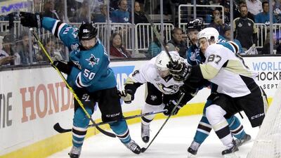 Chris Tierney, left, of the San Jose Sharks skates the puck behind the Pittsburgh Penguins net in Game 4 of the 2016 NHL Stanley Cup Final at SAP Center on June 6, 2016 in San Jose, California. Bruce Bennett/Getty Images/AFP