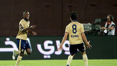 Gilles Yapo, left, of Dubai, celebrates after scoring a goal against Al Jazira earlier in the Arabian Gulf League season. Goals have been few and far between for the club this year. Satish Kumar / The National