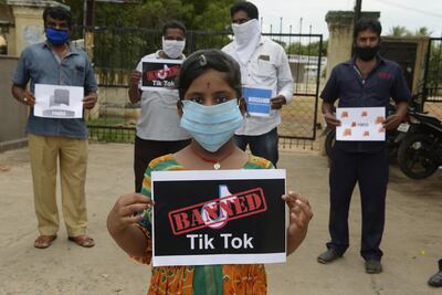 Members of the City Youth Organisation hold posters with the logos of Chinese apps supporting Indian government for banning Tik Tok app. AFP