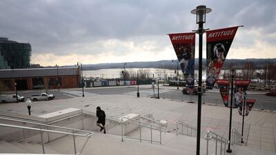 A lone person exercises outside Nationals Park, home to the World Series Champion Washington Nationals, as the stadium sits empty on the scheduled date for Opening Day March 26, 2020 in Washington, DC. AFP