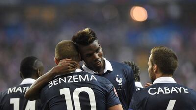 France's Paul Pogba celebrates with Karim Benzema after scoring a goal in their team's 2-1 win over Portugal in Paris on Saturday night. Franck Fife / AFP / October 11, 2014