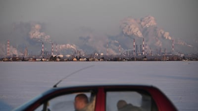 A car drives past the Gazprom Neft's oil refinery in Omsk, Russia. Reuters