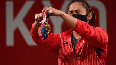 Gold medalist Hidilyn Diaz holds her medal on the podium.