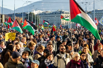 People wave Palestinian flags as they participate in a rally during the 'International Day of Solidarity with the Palestinian People', in Geneva, Switzerland. EPA
