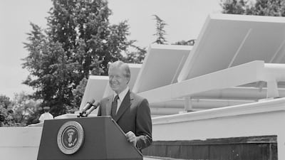 Jimmy Carter announcing his solar energy policy in front of solar panels on the White House roof. National Archives