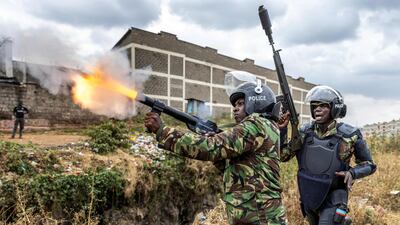 A police officer fires tear gas to disperse anti-government protesters in Nairobi, Kenya. AFP