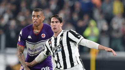Juventus attacker Dusan Vlahovic under pressure from Fiorentina's Igor. EPA