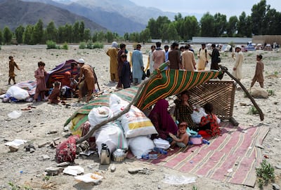 A family takes shelter in a makeshift tent, after an earthquake in the Nurgal district of Afghanistan. Reuters