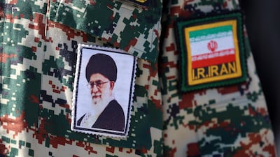 A photo of Iran's supreme leader Ayatollah Ali Khamenei stitched to a man's uniform, as he leaves after Friday prayers at Mosallah mosque in Tehran. EPA