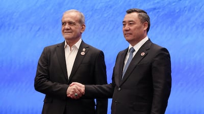 Iranian President Masoud Pezeshkian is welcomed by Kyrgyz President Sadyr Japarov at the Shanghai Co-operation Organisation summit in Kyrgyzstan on Tuesday. Sputnik/Reuters