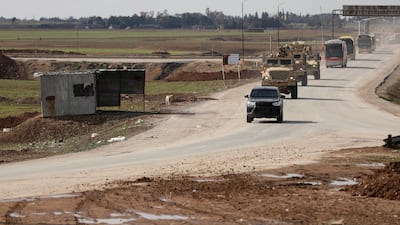 A US military convoy escorts buses transporting ISIS detainees from Syria to Iraq. Reuters