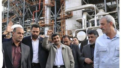 Mahmoud Ahmadinejad shows his delight during a tour of the Abadan oil refinery yesterday. The Iranian president's joy was short lived when a blast during his visit killed at least four people and wounded 25. Amir Pourmand / ISNA / AFP