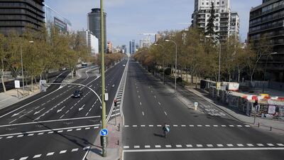 A woman crosses the usually busy La Castellana avenue in Madrid. AFP