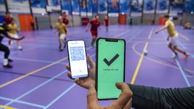 A QR code is displayed in a sports hall in Heerhugowaard, Netherlands. Owing to tightened coronavirus measures, indoor sports associations are obliged to check the smartphones of players and visitors. EPA