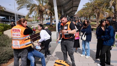 Members of Israeli security and emergency services attend the scene of a stabbing attack at a bus station in Haifa, Israel, on Monday. AFP