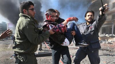 Lebanese men carry an wounded man at the site of an explosion, near the Kuwaiti Embassy and Iran's cultural centre, in the suburb of Beir Hassan, Beirut, Lebanon. AP Photo