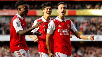 Arsenal's Brazilian midfielder Gabriel Martinelli (R) celebrates scoring his team's first goal with teammates during the English Premier League football match between Arsenal and Liverpool at the Emirates Stadium in London on October 9, 2022. (Photo by Ian Kington / IKIMAGES / AFP) / RESTRICTED TO EDITORIAL USE. No use with unauthorized audio, video, data, fixture lists, club/league logos or 'live' services. Online in-match use limited to 45 images, no video emulation. No use in betting, games or single club/league/player publications.