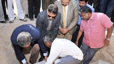 The Indian consul general Sanjay Verma (from left) and the Indian Association Sharjah members lay the foundation stone for the new crematorium in Sharjah.