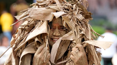 Teacher Leonila Arucan, dressed in dried banana leaves, takes part in the mud festival outside the church of St John the Baptist at Bibiclat, Nueva Ecija province, northern Philippines. All photos: AP