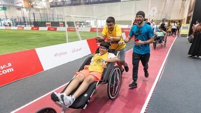 Children jog around the track at Dubai Sports World.