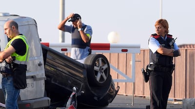 A policeman stands by a car involved in a terrorist attack in Cambrils, a city 120 kilometres south of Barcelona. Lluis Gene / AFP Photo