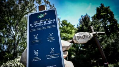 Placards indicating the sanitary measures to follow in the aim to curb the spread of the Covid-19 are seen at the Asterix amusement park in Plailly, outskirts of Paris, one week before its reopening. AFP