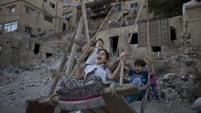 Jordanian children enjoy a ride on an improvised swing for the price of 25 piastres, (35 US cents) for 5 minutes, during Eid Al Fitr holiday, in Amman, Jordan. Muhammed Muheisen / AP photo