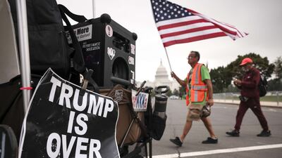 Supporters of those charged in the January 6 attack on the US Capitol walk past a counter-protest sign as they arrive for the "Justice for J6" rally near the US Capitol, September 18, 2021 in Washington. Getty / AFP