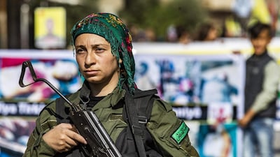 A member of the Kurdish Internal Security Force known as Asayesh stands guard during a protest against the Turkish assault on northeastern Syria, in the town of Qamishli. AFP