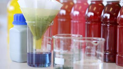 A beaker filled spirulina extract is used to make a blue colour at the offices of GNT. Seth Wenig / AP Photo