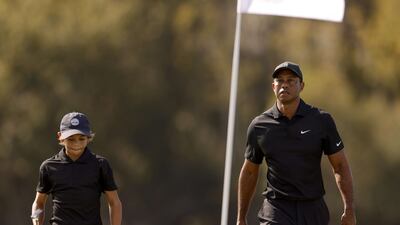 Tiger Woods and Charlie Woods walk on the course during the pro-am ahead of the PNC Championship on the Grande Lakes Orlando course at the Ritz-Carlton Golf Club. AFP