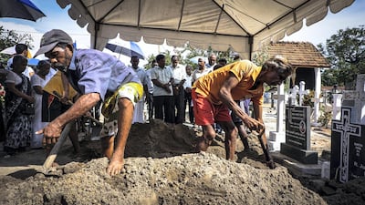 Grave diggers bury a victim of the suicide bomb attacks in Negombo, Sri Lanka, April 23, 2019. Jack Moore / The National.