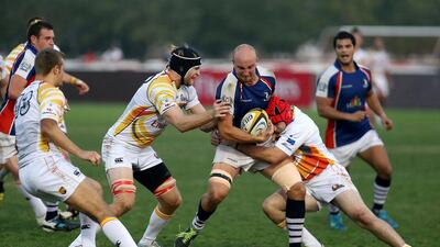 Nick Taylor, with ball, of Jebel Ali Dragons in action during the match against Dubai Hurricanes at the Sevens rugby ground in Dubai on January 31, 2014. Pawan Singh / The National