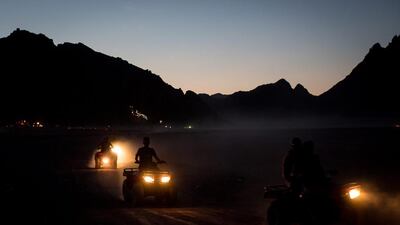 A few tourists are seen during a sunset quad bike tour.