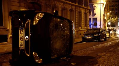 A turned-over car near the Champs-Elysees in Paris. AFP