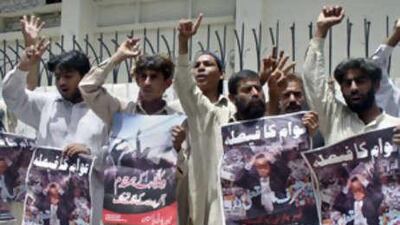 Protesters holding posters that read "Decision of nation, Musharraf immediately resign" take part in a rally in Hyderabad yesterday.