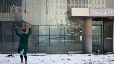 A woman throws snow in the air at a square in Johannesburg. AFP