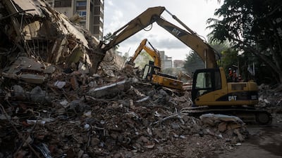 Emergency teams remove rubble after the twin tremors. EPA