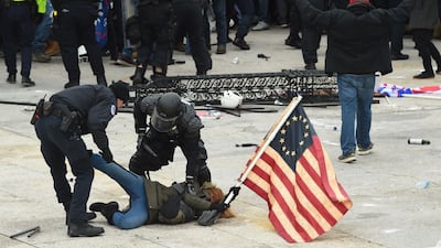 Police detain a person as supporters of US President Donald Trump protest outside the US Capitol. AFP